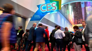 A crowd gathers under a CES banner in Las Vegas