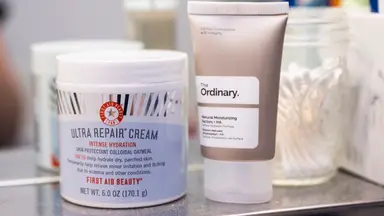 A jar and tube of moisturizer next to each other on a shelf.