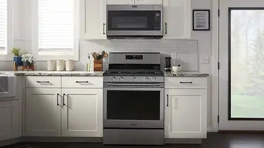 Maytag MGR7700LZ Gas range in modern kitchen setting.