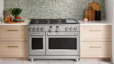 The GE Cafe C2Y486P3TD1 Gas Range hooked up in place inside a kitchen.