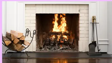 Wood logs burning inside of fireplace.