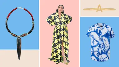 A necklace with a long central bead, a yellow houndstooth dress, a gold initial ring, and a blue dyed shirt.
