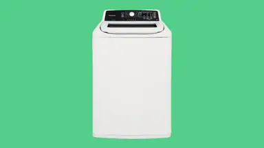 The Frigidaire FFTW4120SW top-load washing machine sits on a green background