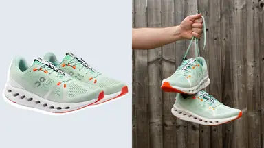 Green sneakers against a blue background, and also being held up by its laces on the right.
