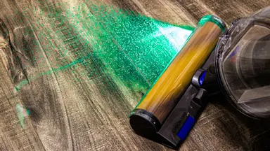The Dyson Gen5outsize cleaning a hardwood floor with its Fluffy Optic head.