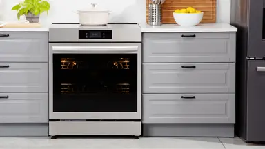 Frigidaire Gallery GCFI3060BF 30-inch Induction Range in between two drawers in modern kitchen setting.