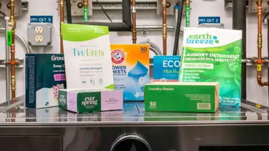 Grove Co., Tru Earth, Ever Spring, Arm & Hammer, Ecoas, Laundry Club, and Earth Breeze laundry sheets on a washing machine