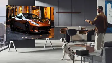 Man and dog watch an LG OLED television