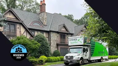 Reviewed's Readers' Choice Award winner badge over an image of a moving truck at a house