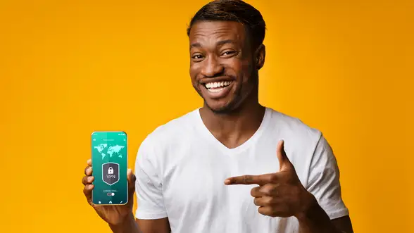A person is holding a smartphone that's protected by a VPN