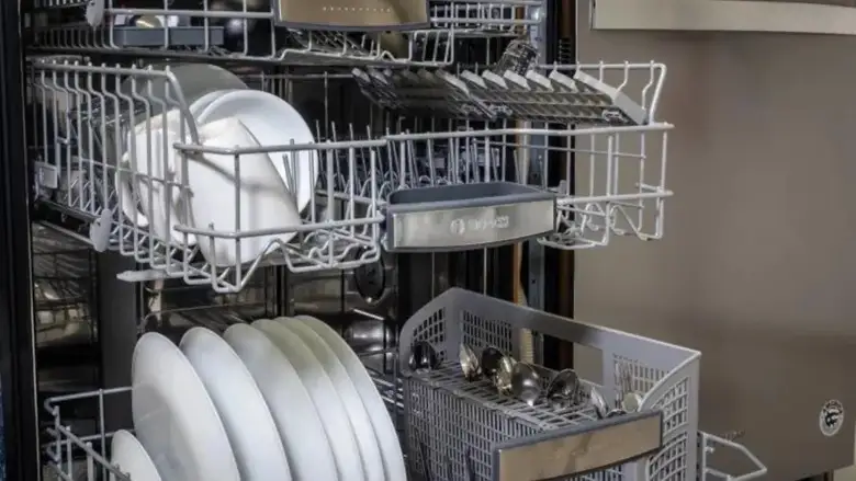 A Bosch dishwasher with its middle and upper racks open.