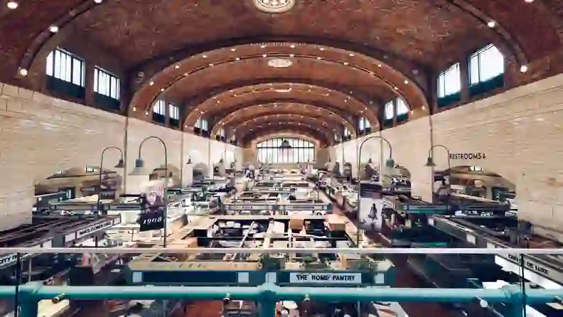 Interior of West Side Market's vaulted, tiled hall lined with vendor stalls