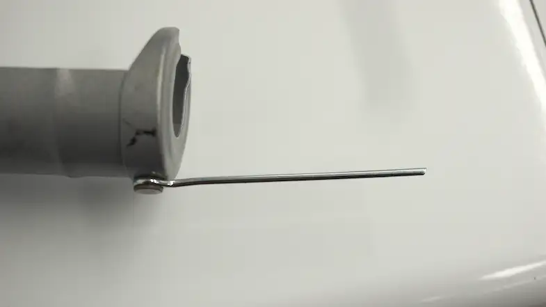 The tine on the caulk gun that punctures caulk tubes.