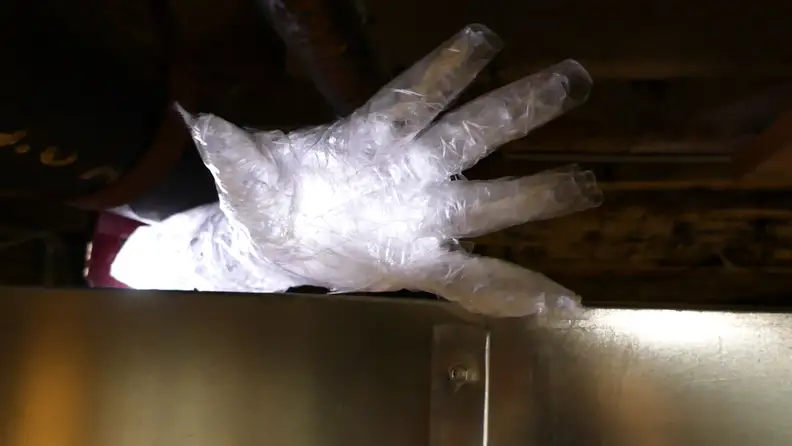 A ghostly packing tape cast hand, illuminated by a hidden light source.