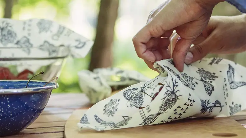 Wrapping food in beeswax wrap.