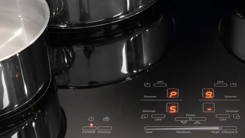 A close-up of the Whirlpool GCI3061X induction cooktop