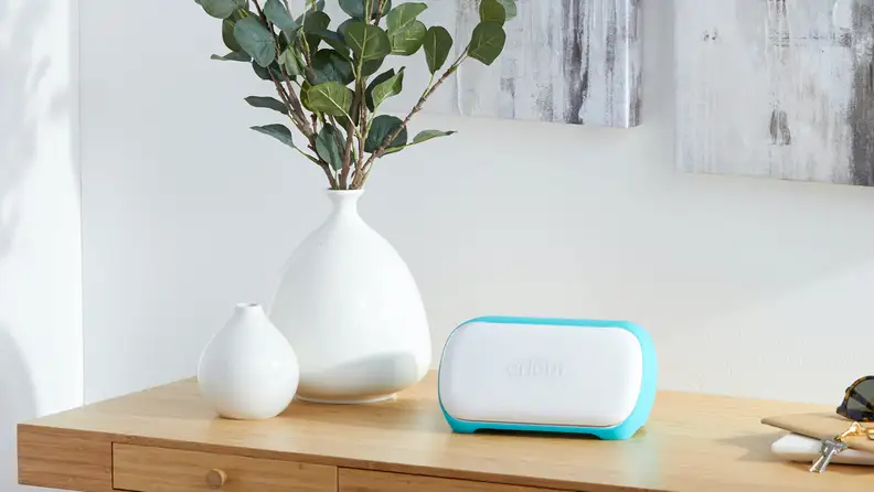 Cricut craft machine sitting on top of table next to white plant vases