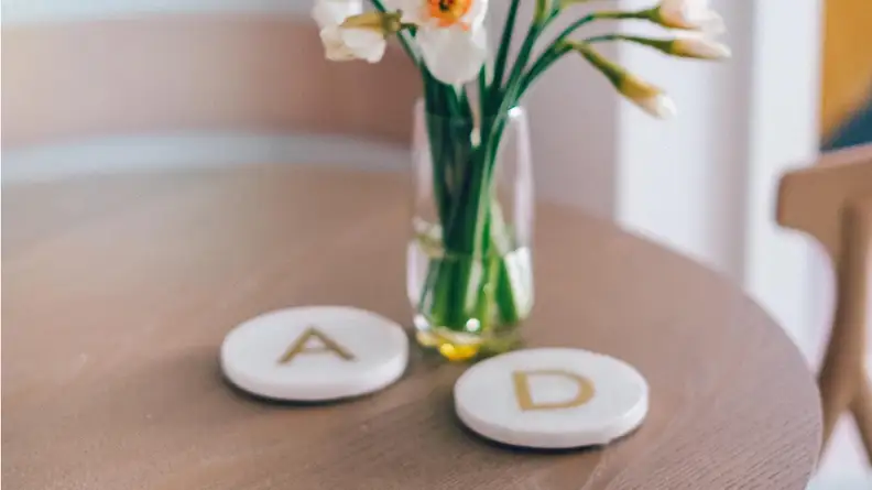 These coasters are handmade from white marble and acacia wood.