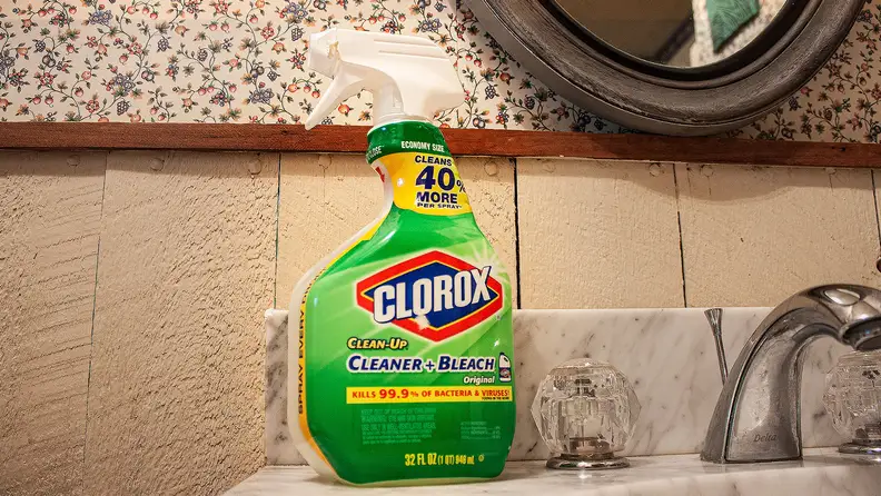 A spray bottle of Clorox Clean-Up and Bleach sits atop a bathroom sink.