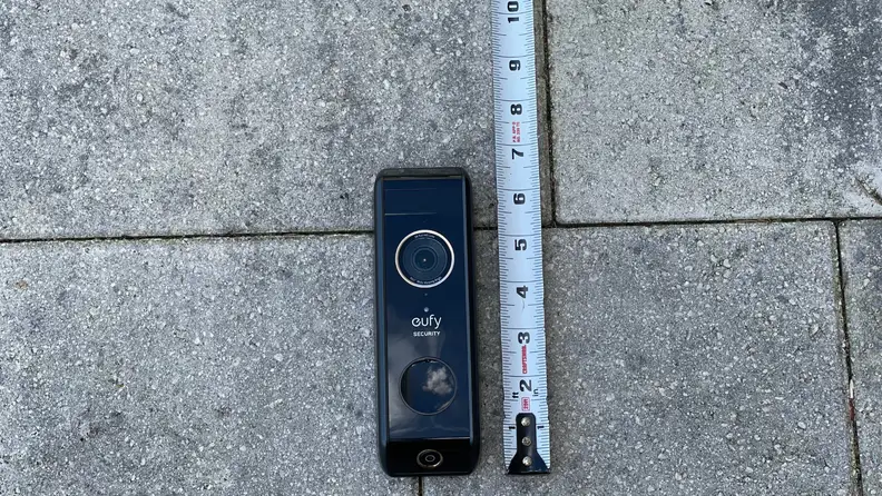 A video doorbell appears next to a tape measure.