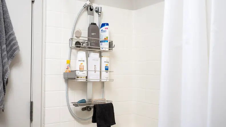 Simplehuman Adjustable Shower Caddy hangs in a tiled shower