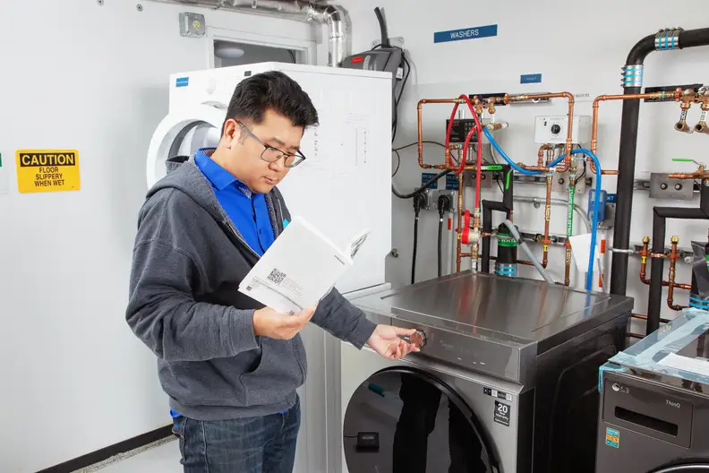 A person testing a front load washing machine.