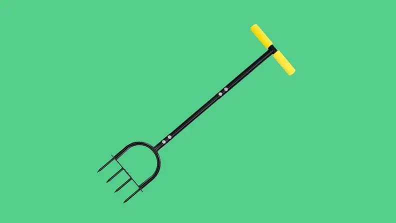 Aerating handheld spike in front of a background.