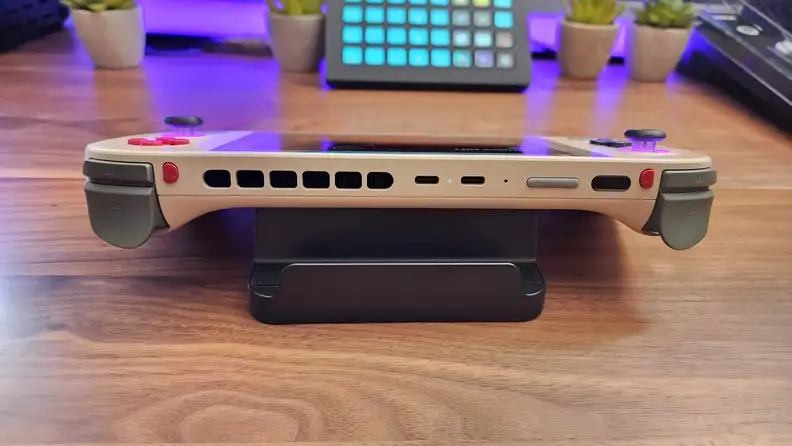 Close-up shot of the left side of the Ayaneo 2S Handheld gaming computer on top of hardwood surface.