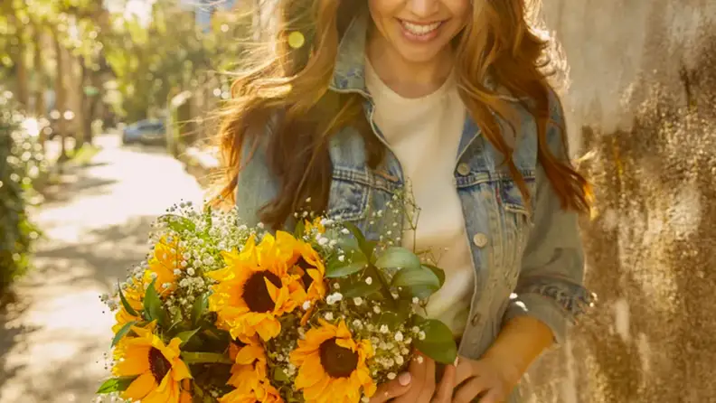 Woman holding sunflowers