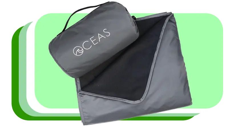 Outdoor blanket folded in square next carrying pouch.