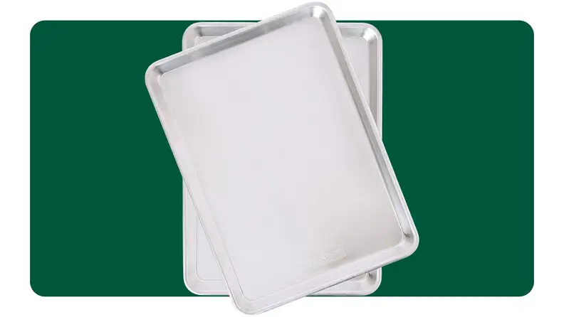 Two baking sheets on a green background