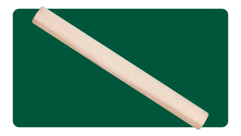 Two hand peeling an apple on a cutting board, with a rolling pin closeby