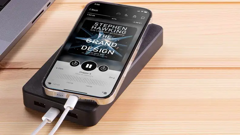 A close-up of the Mophie Powerstation XXL, plugged into a phone that's resting on top of it.