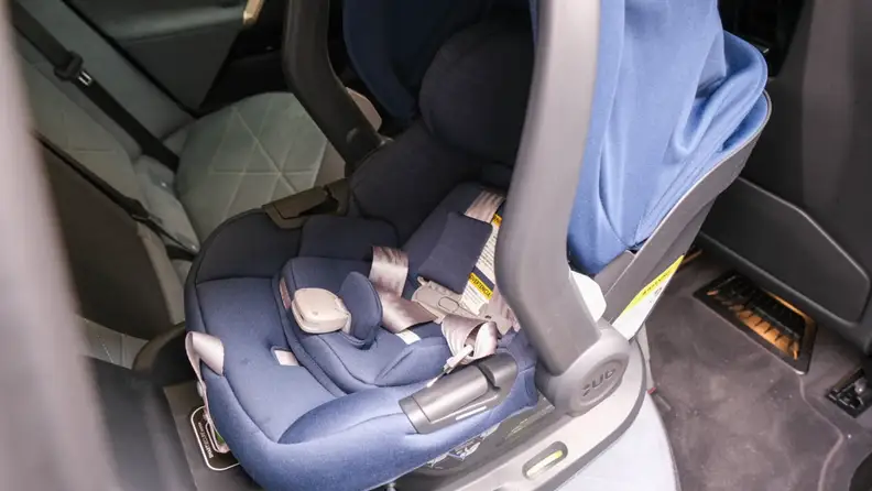Navy blue Uppababy Mesa Max car seat strapped into backseat of car.