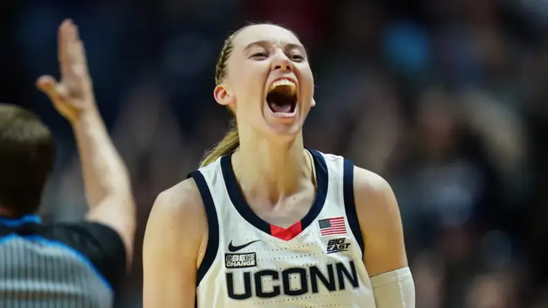 Paige Bueckers looking excited during a basketball game.