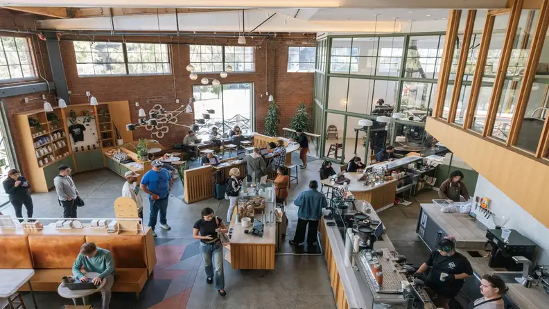 Aerial view of a busy coffee shop with customers and baristas