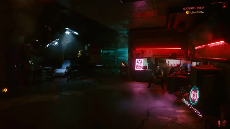A man sitting near a computer screen in a basement