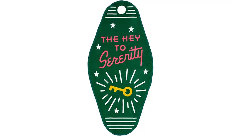 Green towel in the shape of a hotel key.