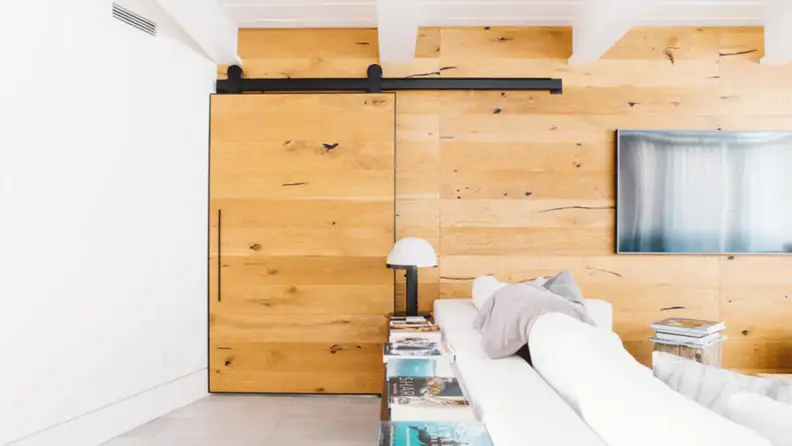 A sliding barn door easily opens and closes, hiding your mudroom from guests.