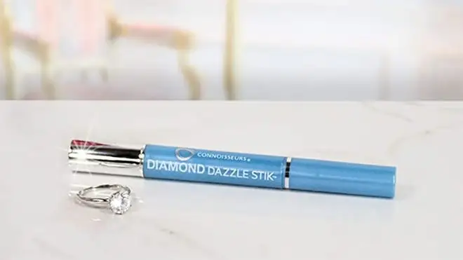 A Diamond Dazzle Stick pen on a marble table