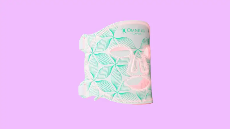 The pink, white, and teal Omnilux Contour Face Mask on a purple background.