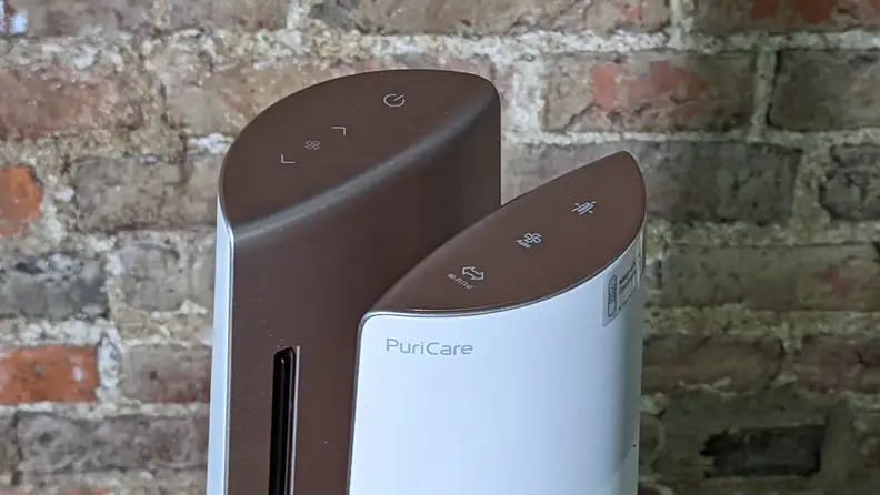 A top view of the LG PuriCare showing the buttons, against a brick wall.