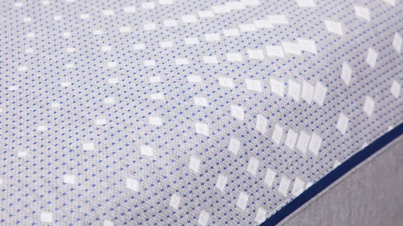 A close up view of the printed fabric on top of Sealy Posturepedic mattress.