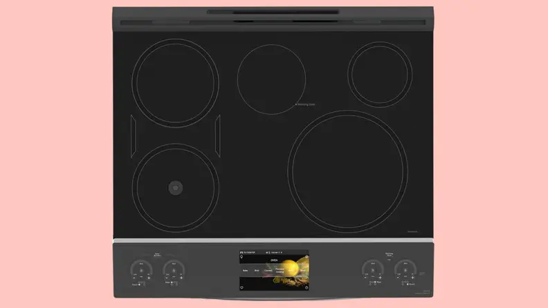 Close up of a stovetop against a pink background.