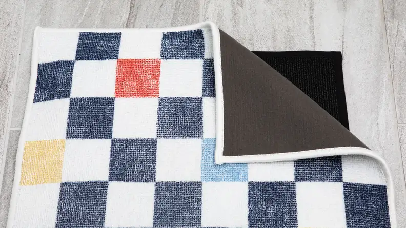 The mat with a folded corner, revealing another mat underneath.