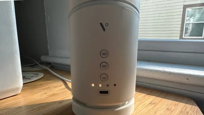 A close-up of the back of the Vitruvi diffuser that shows the time and light controls.