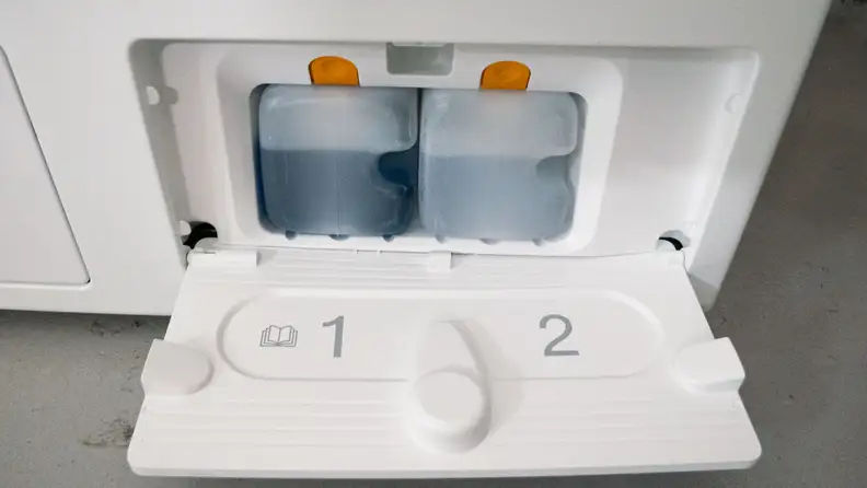 A close-up of the machine’s auto-dispensing detergent compartment.