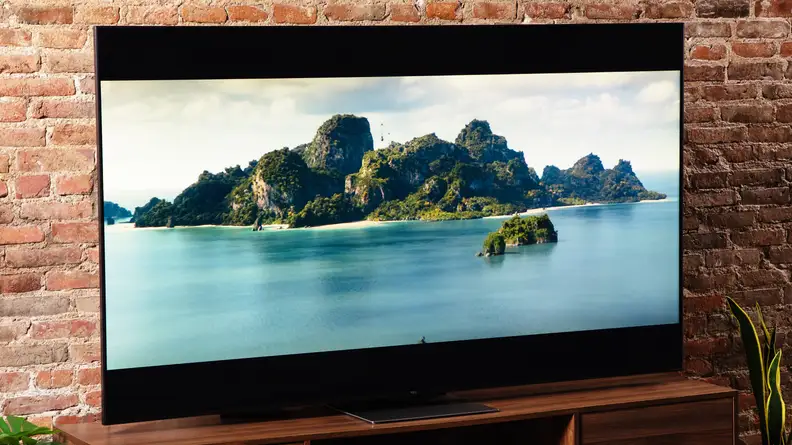 TCL 75R655 with underwater display in front of brick wall indoors.