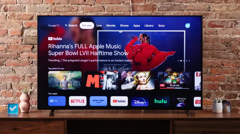 The Sony X90K LED TV home screen featuring a picture of Rhianna singing and smart apps, such as, Netflix, YouTube, Amazon, Hulu, and Disney Plus.