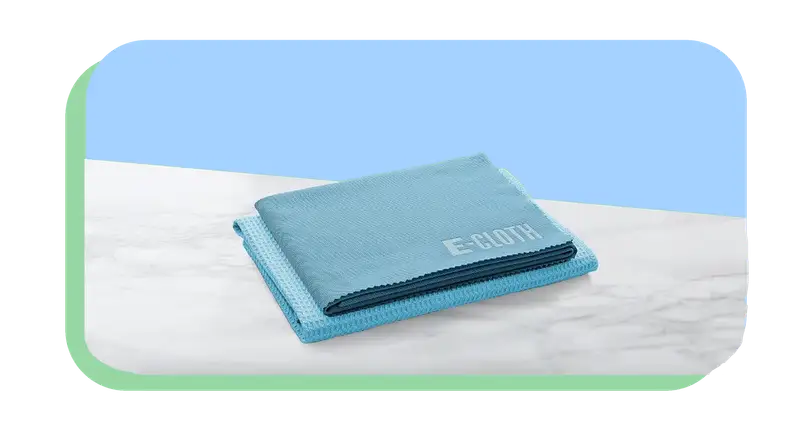 Stack of blue microfiber cloths sitting on top of granite countertop surface.